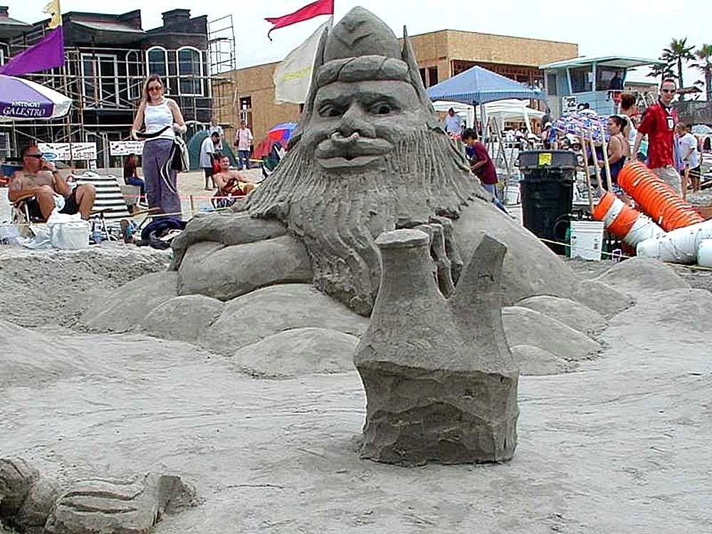 A large sandcastle built on a beach