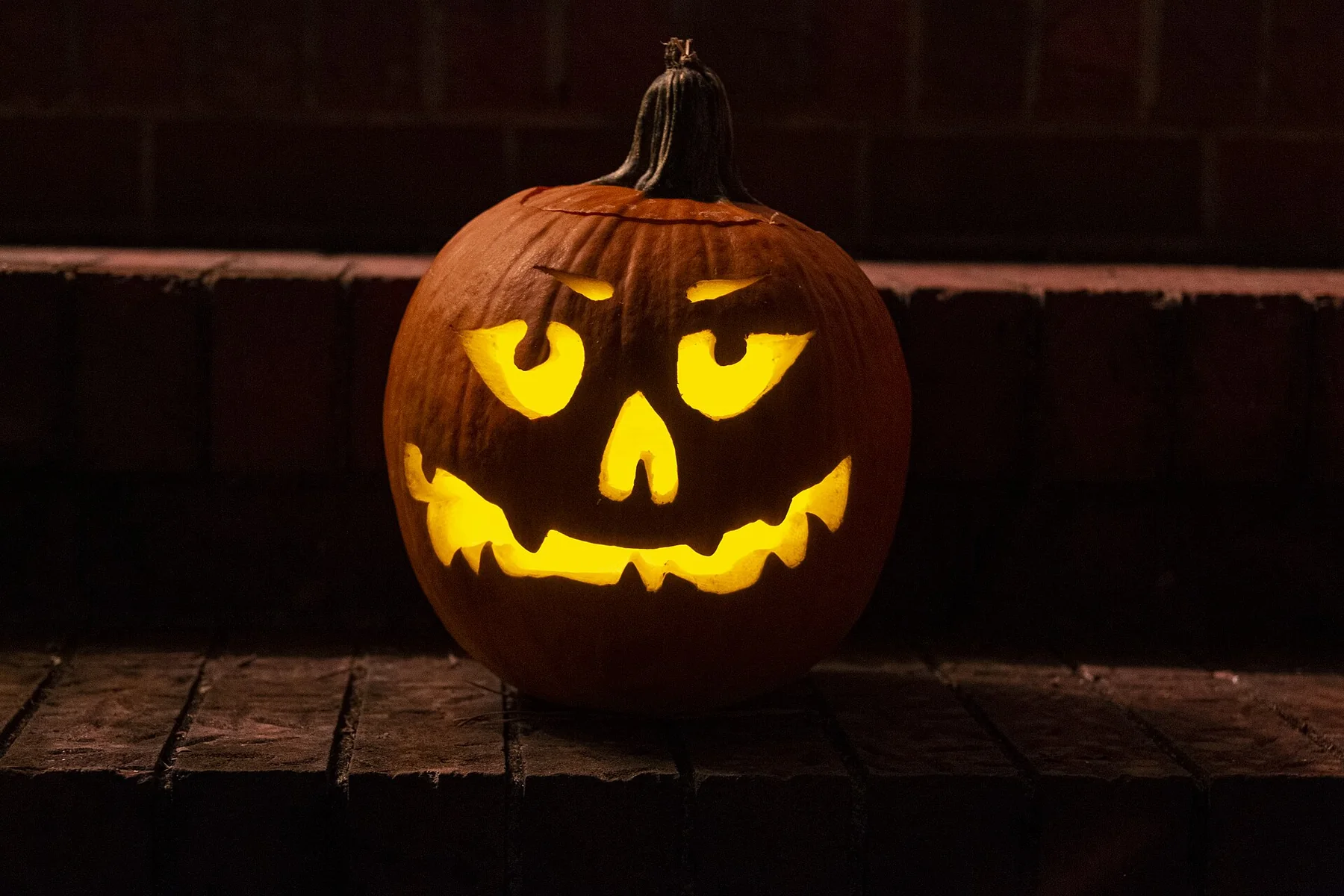 An illuminated jack-o-lantern at night