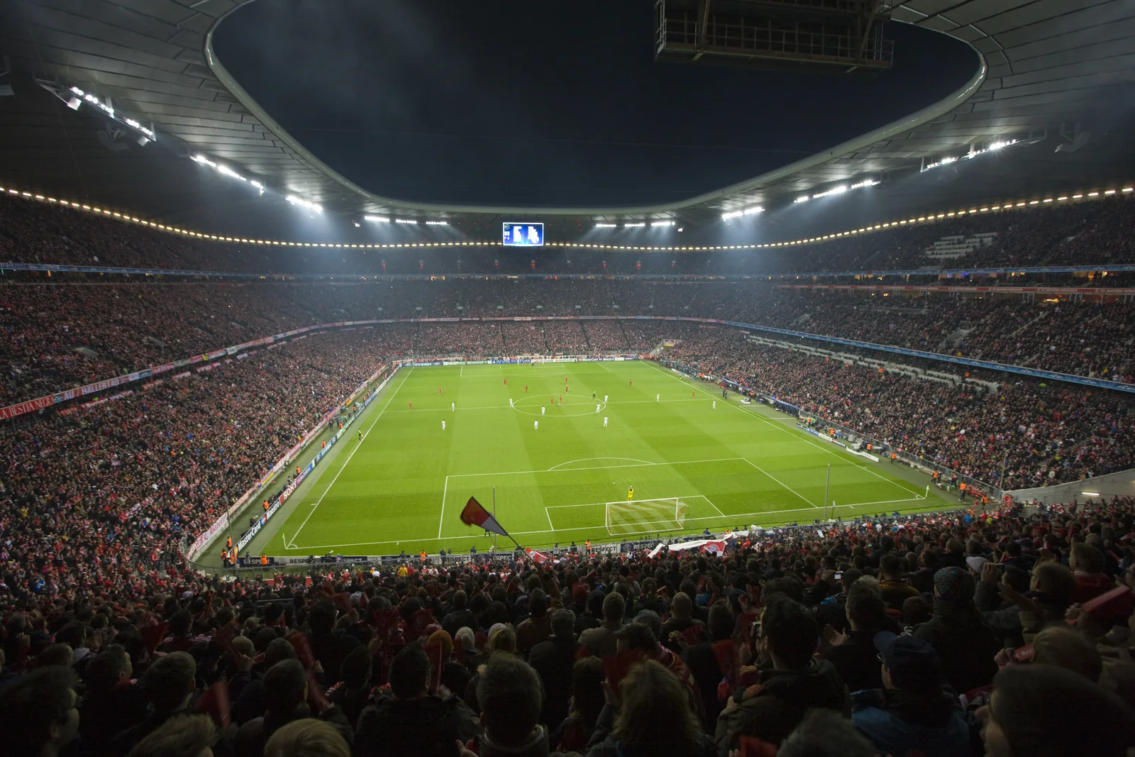 A brightly lit soccer stadium at night