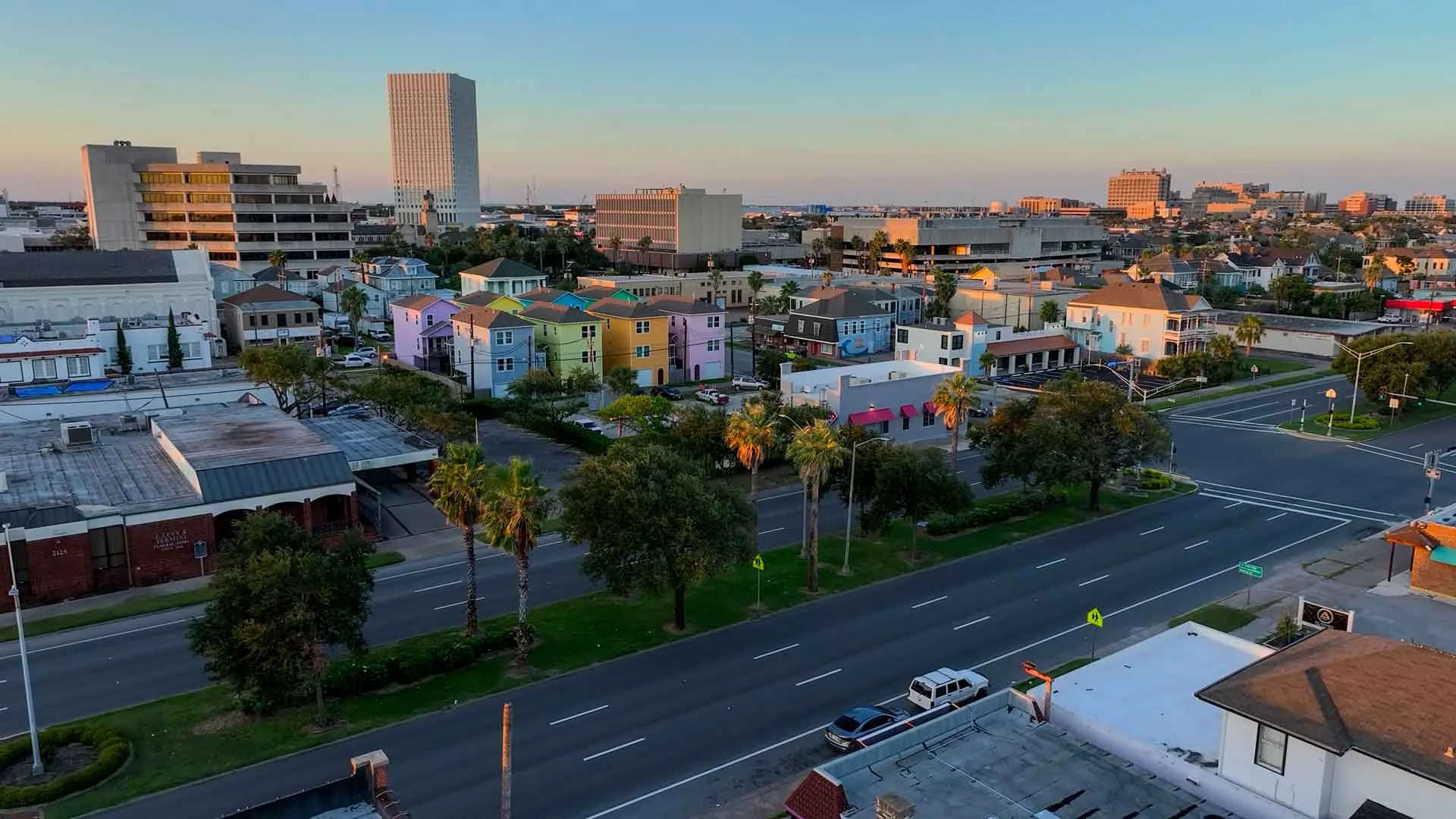 An aerial view over downtown Galveston and Broadway in evening light.