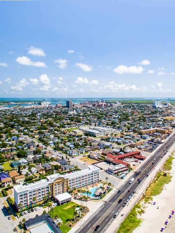 Aerial view across Galveston neighborhoods and the seawall